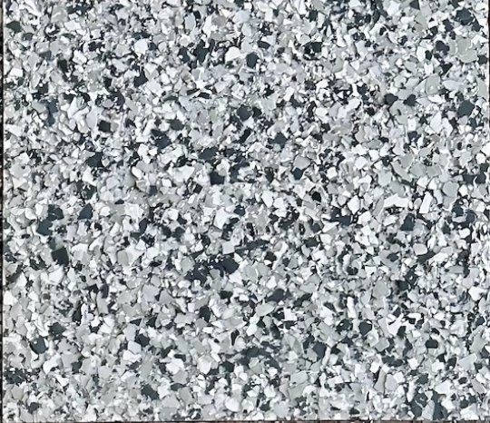 Gravel epoxy flake floor color sample with white, light gray, charcoal, and black flakes.