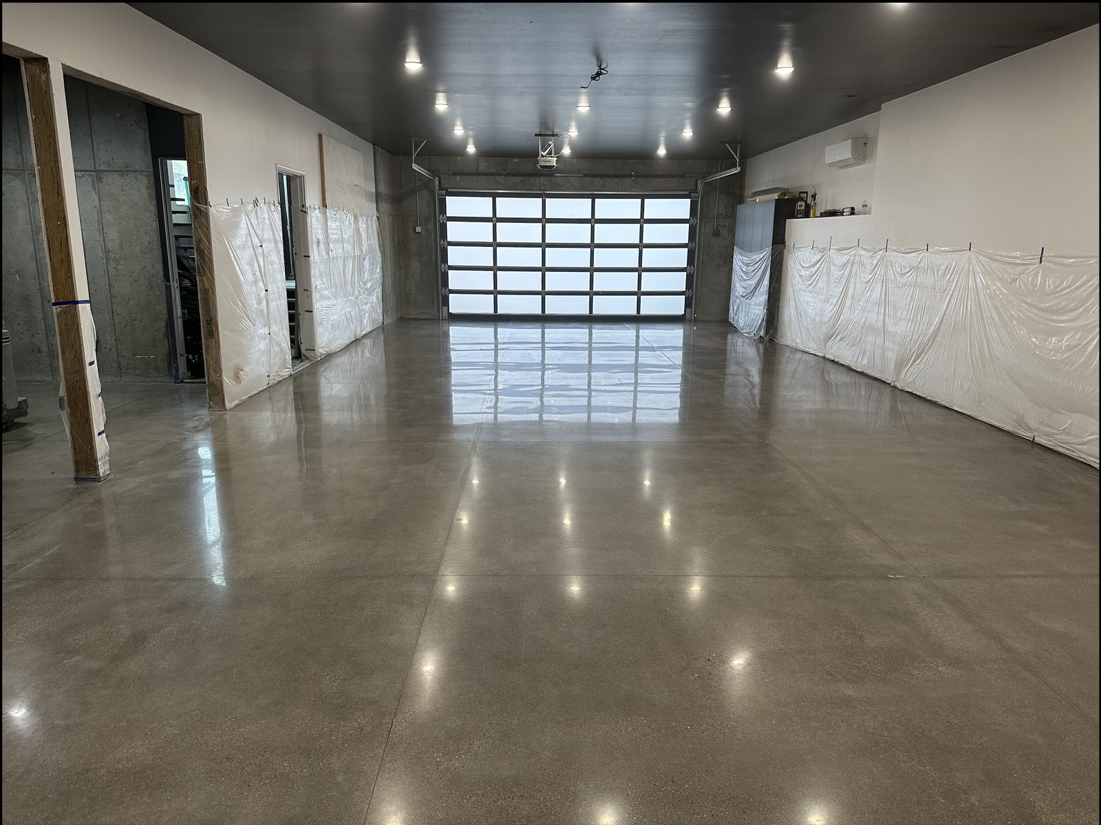 Large residential garage with full polished concrete floor.