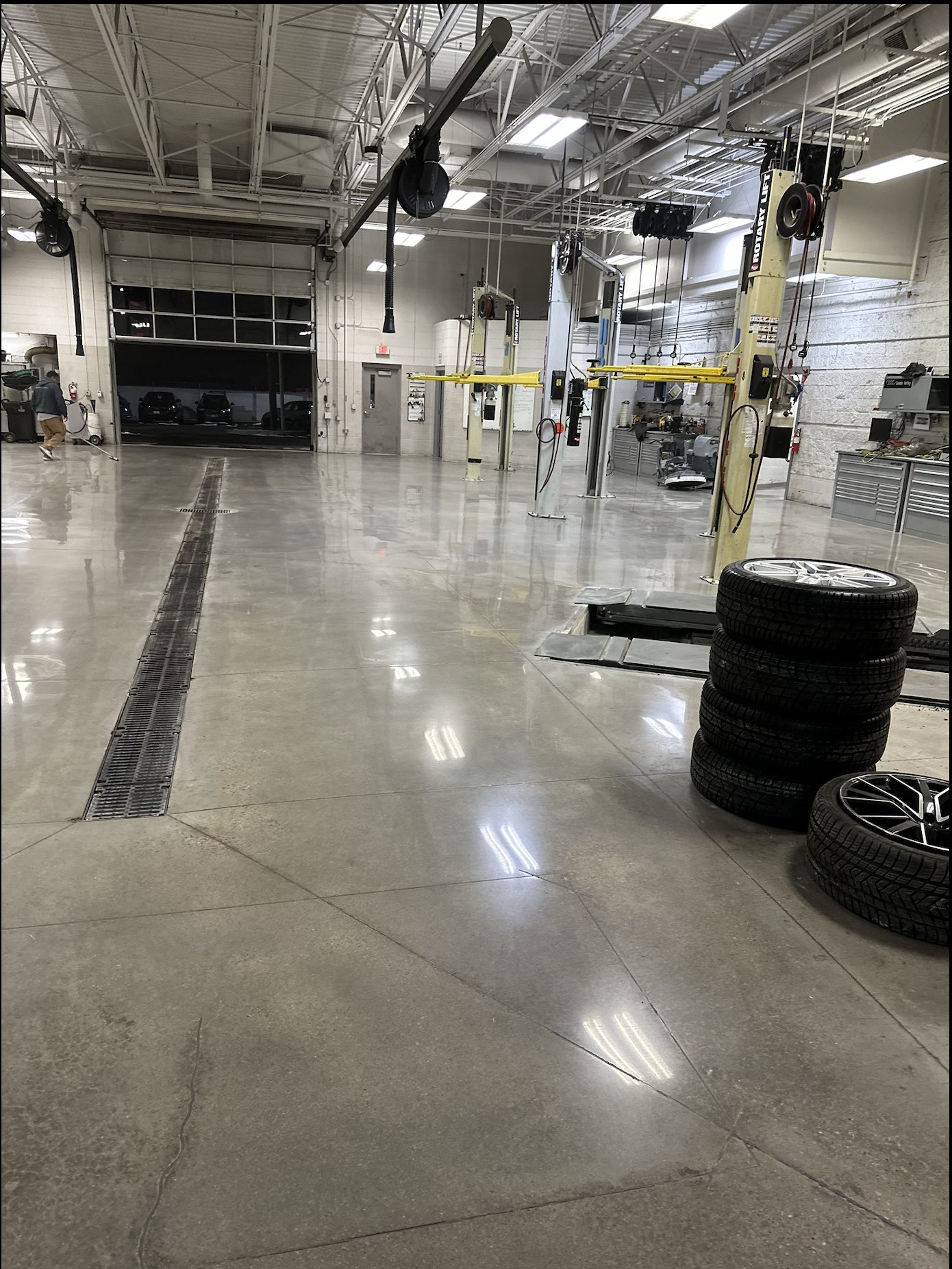 Audi dealership service shop with polished concrete floor and automotive lifts.