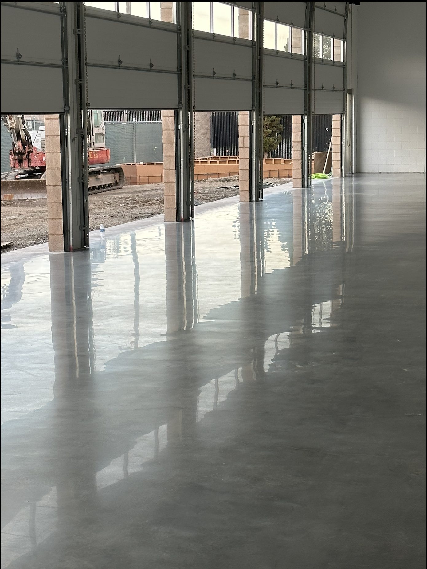 Commercial dealership shop bay with polished concrete floor.