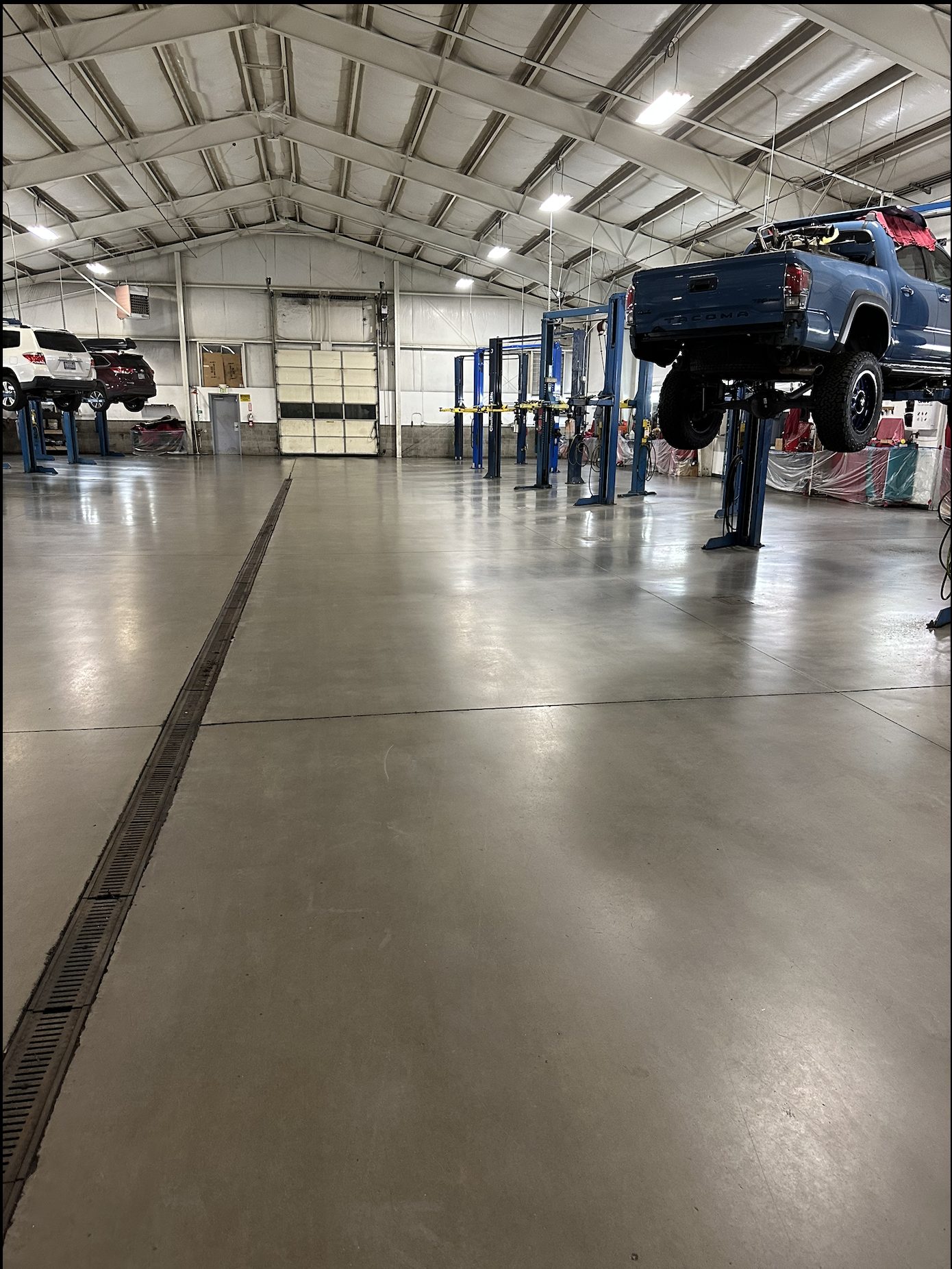 Dealership shop concrete floor after clean and seal work.